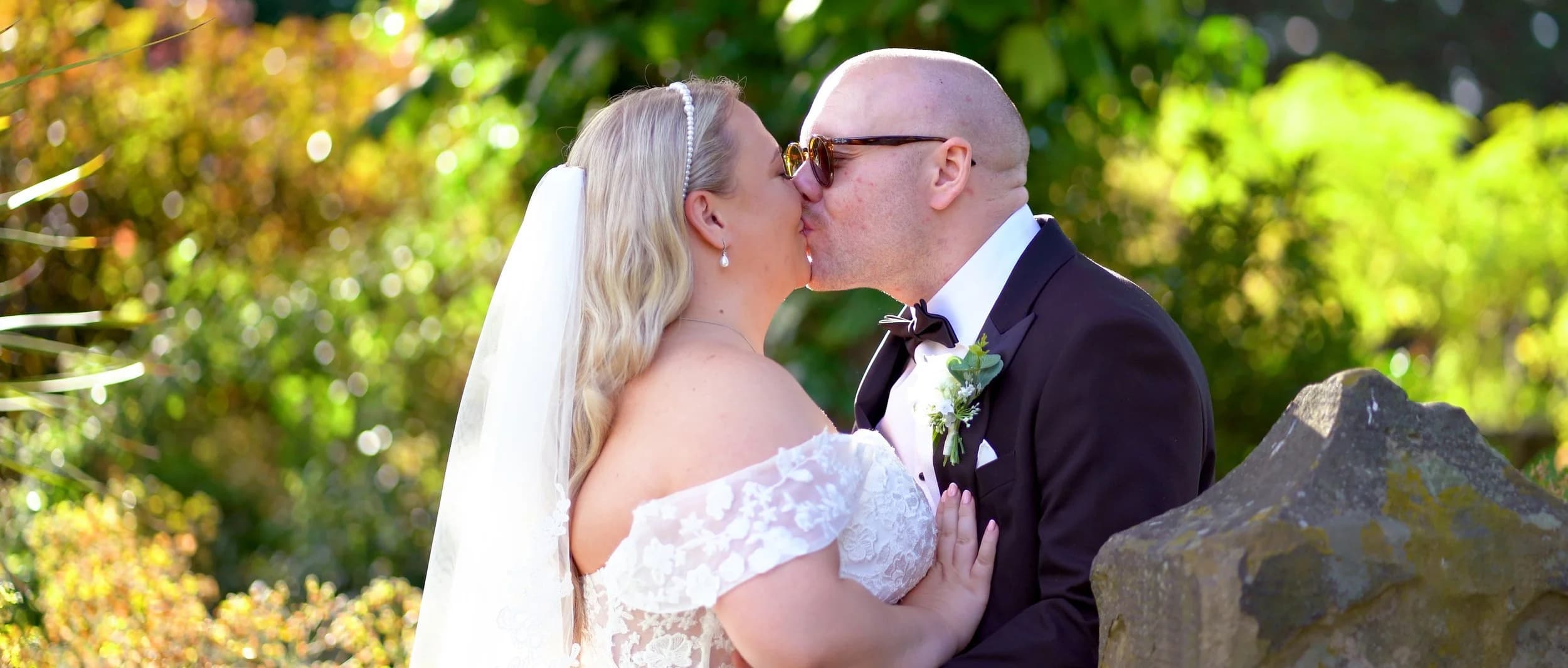 Jacob White in a wedding setting holding a camera